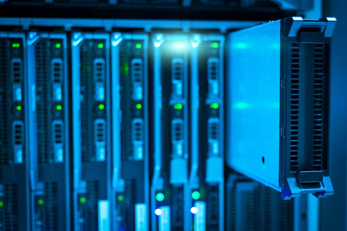 a server rack cooling fan spinning rapidly in a dark datacenter