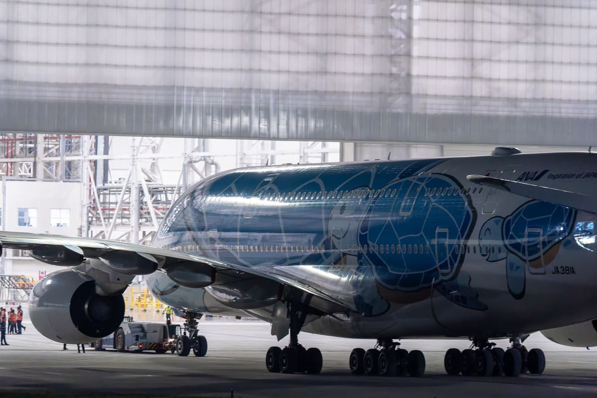 a massive jet engine blowing air onto a tiny soccer ball