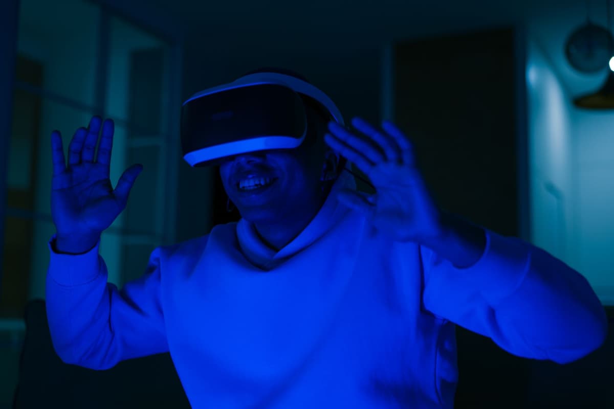 a person wearing a VR headset looking at a glowing wireframe city