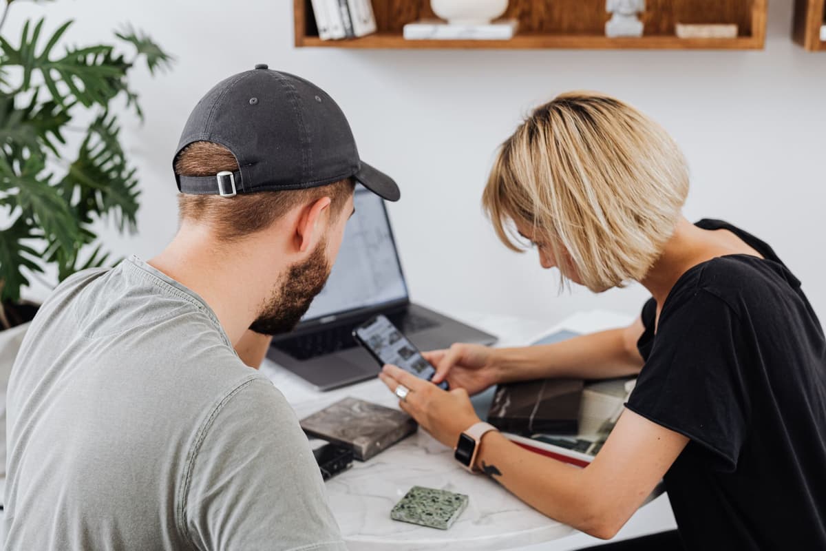 two people leaning over a shared sketchbook