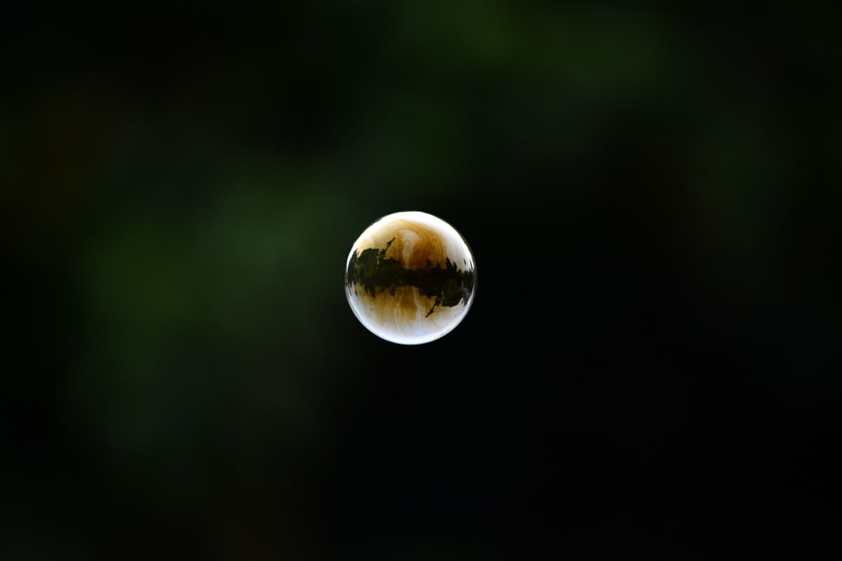 a single gold-plated satellite floating in dark space