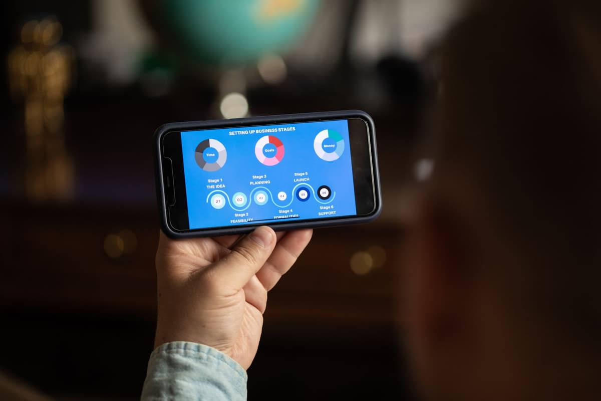 a high-end smartphone displaying a football stadium map with overlapping digital data lines
