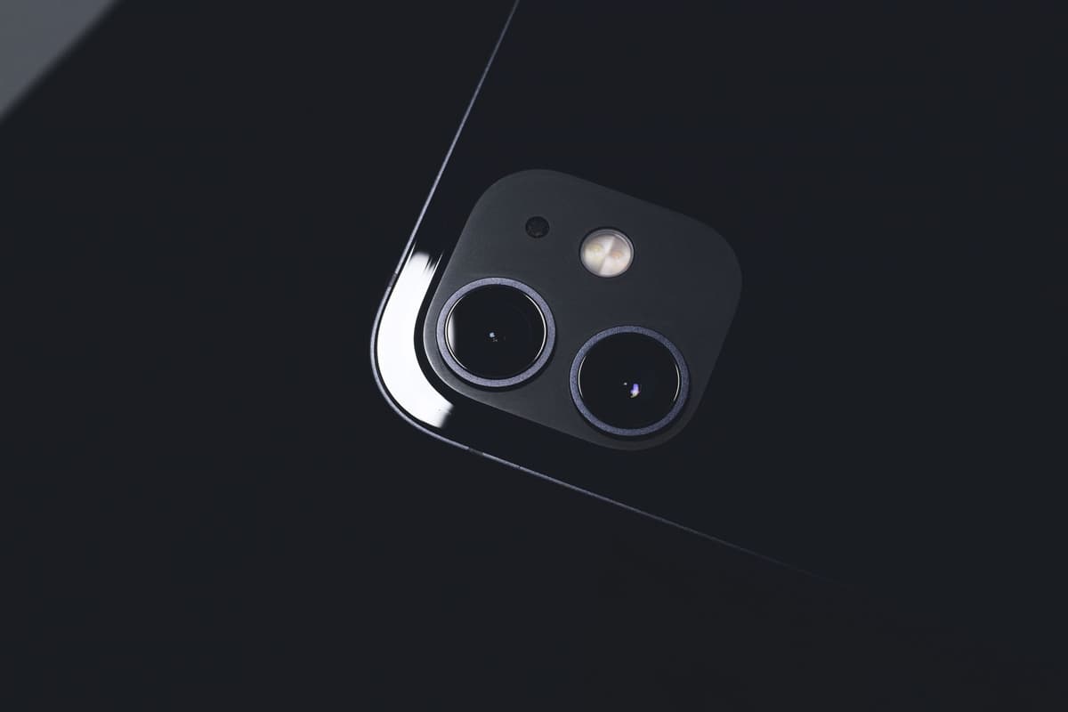 a dusty action camera sitting next to a shiny smartphone