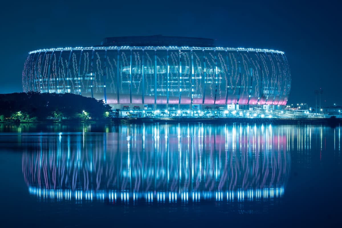 a futuristic stadium gate with glowing blue scanners