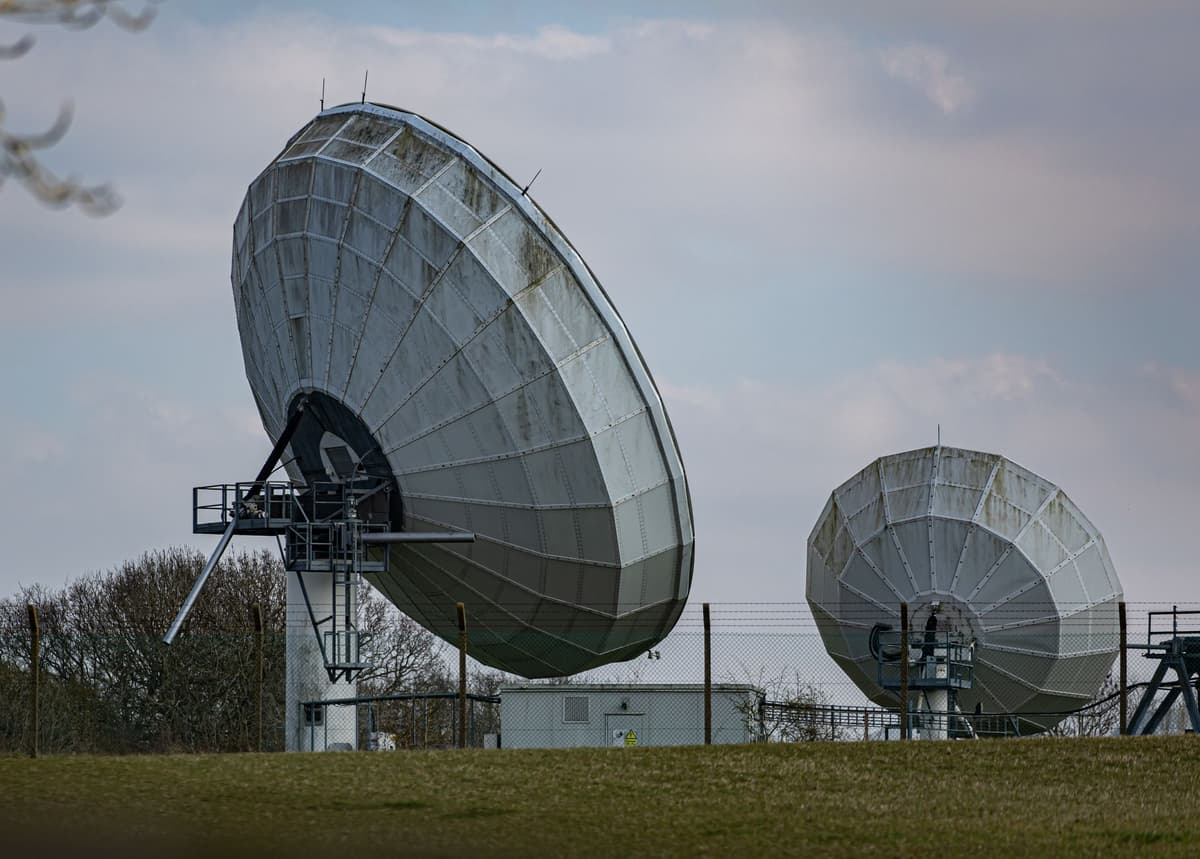 a massive grid of tall metal radio antennas against a snowy backdrop