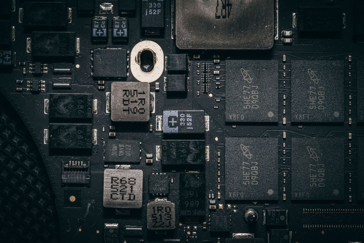 a high-resolution macro shot of a green circuit board with tiny silver components