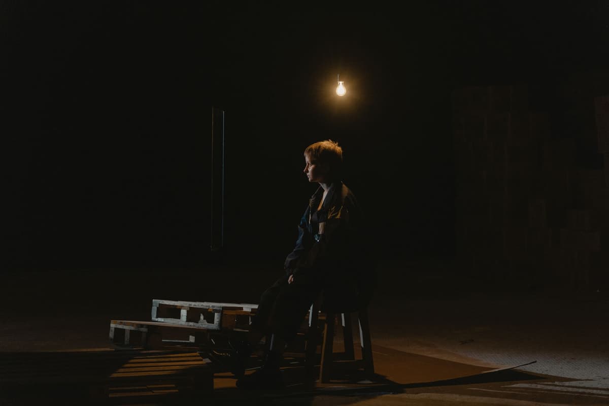 a single lightbulb hanging in an empty concrete room