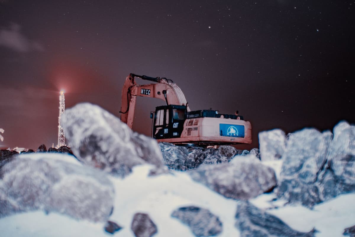 a heavy industrial drill boring into blue Antarctic ice