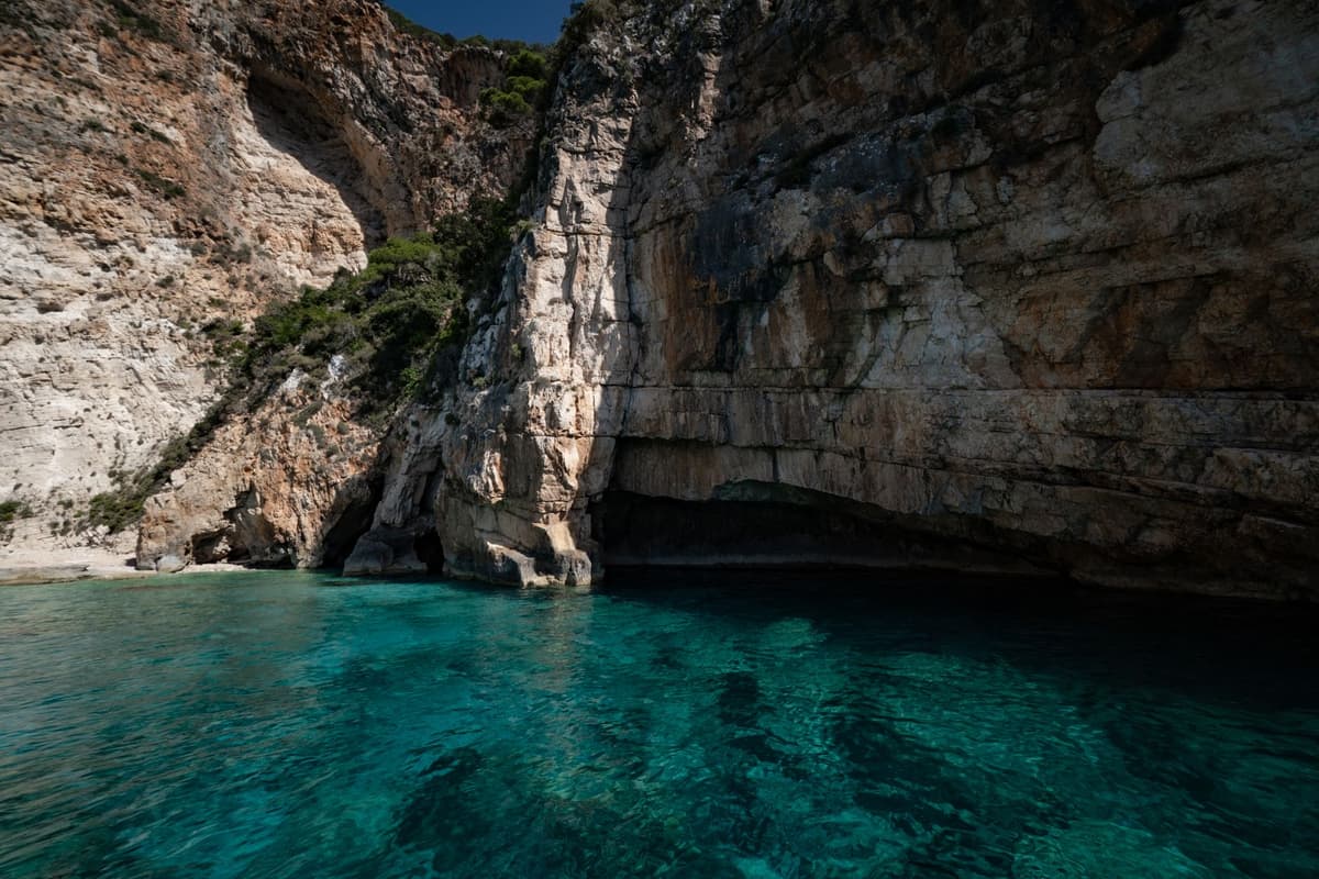 a massive limestone archway overlooking a turquoise bay