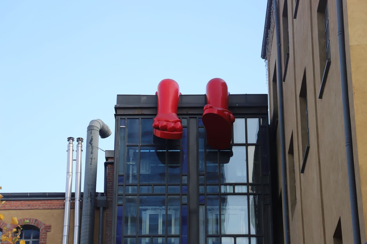 a giant metal zipper teeth installed on a brick wall