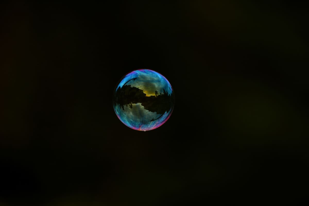 a single bubble rising through dark water