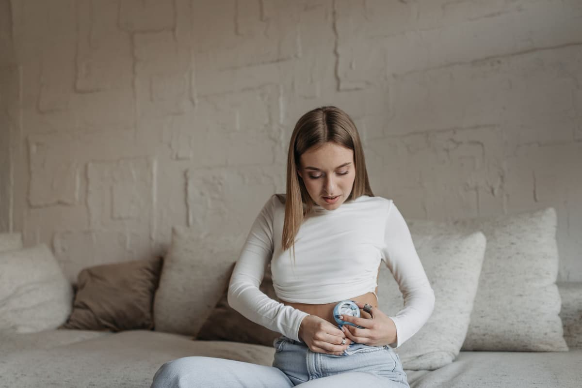 a futuristic insulin pump with a tiny 'Access Denied' skull icon on its screen