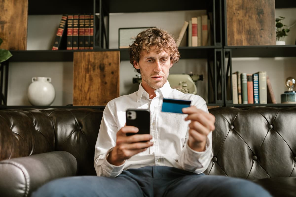a man in a suit holding an empty wallet