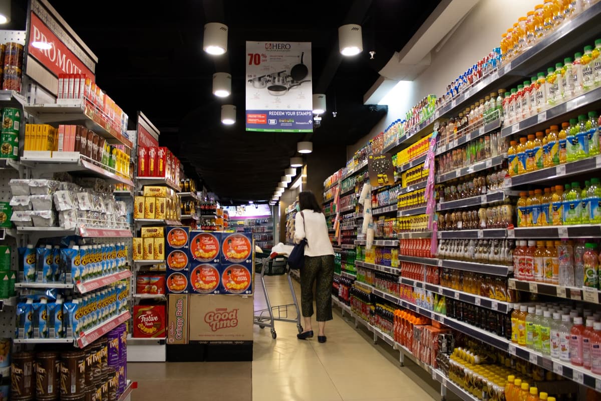 empty supermarket shelves with a single bottle of water