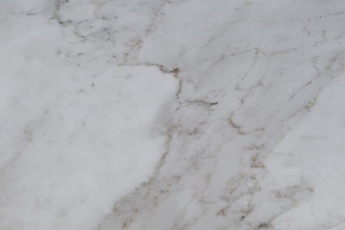 a single gold key resting on a polished dark marble table