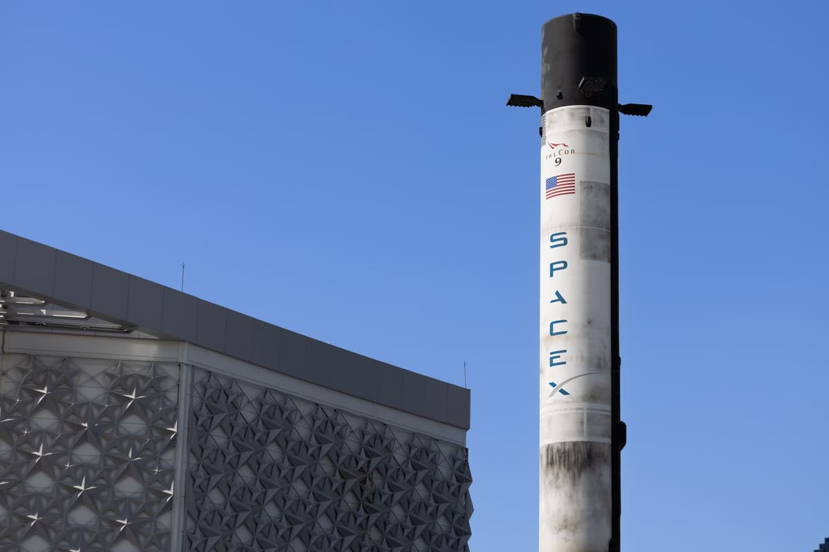 a massive blue rocket engine nozzle on a test stand