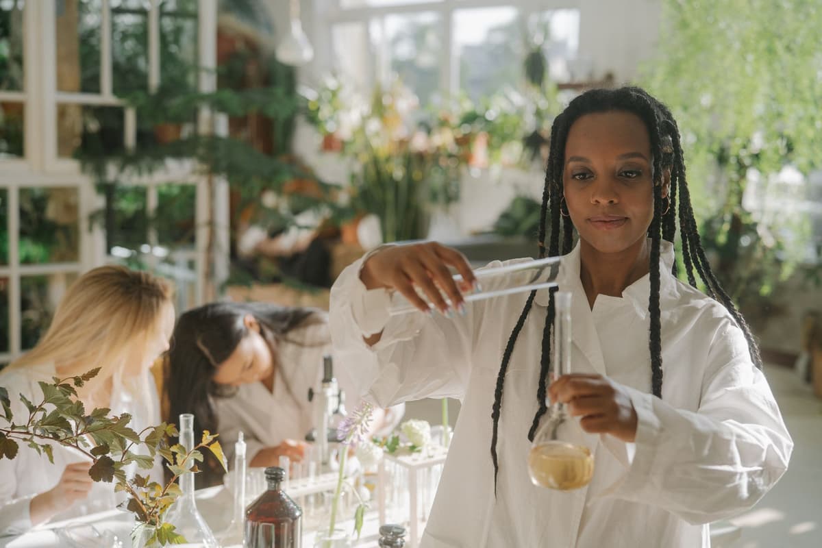 a scientist in a white lab coat standing in a tropical jungle