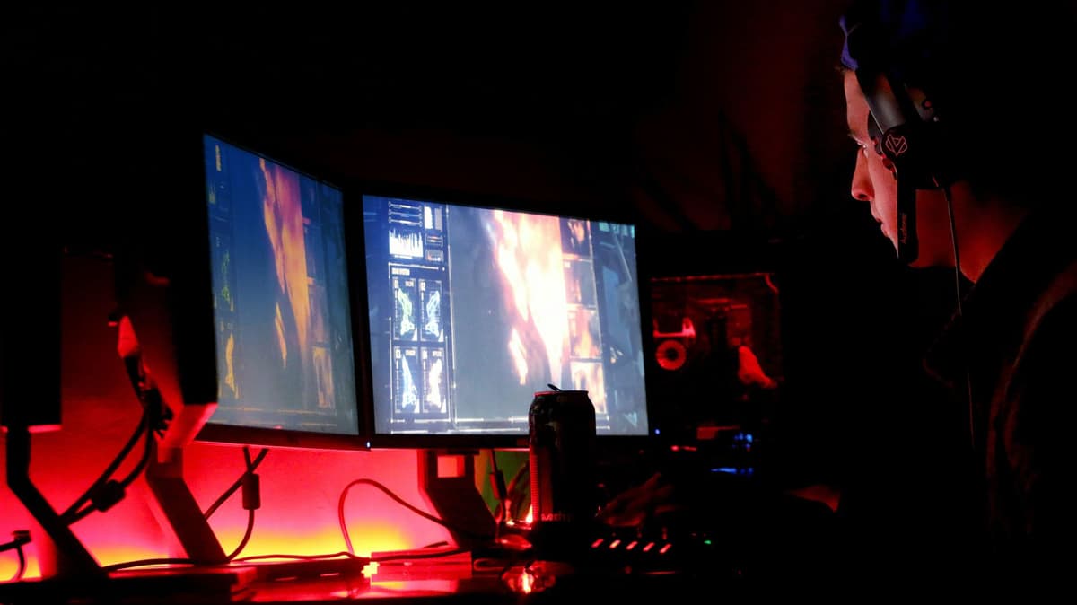 a heavy beige computer monitor glowing in a dark room