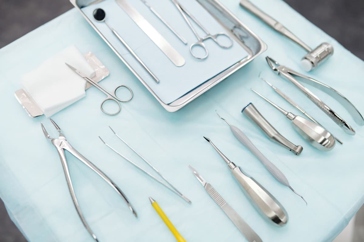 a high-end smartphone lying on a sterile metal medical tray
