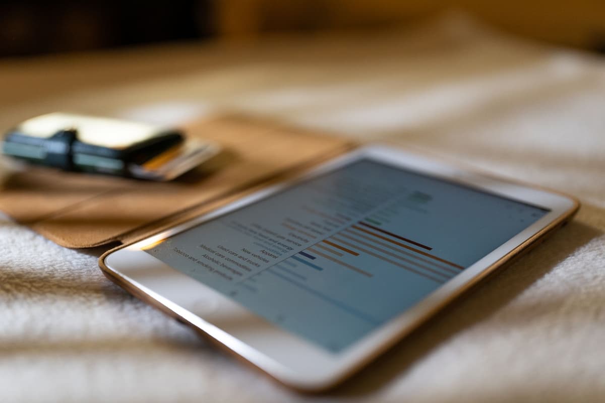 a vintage barometer next to a modern glowing tablet