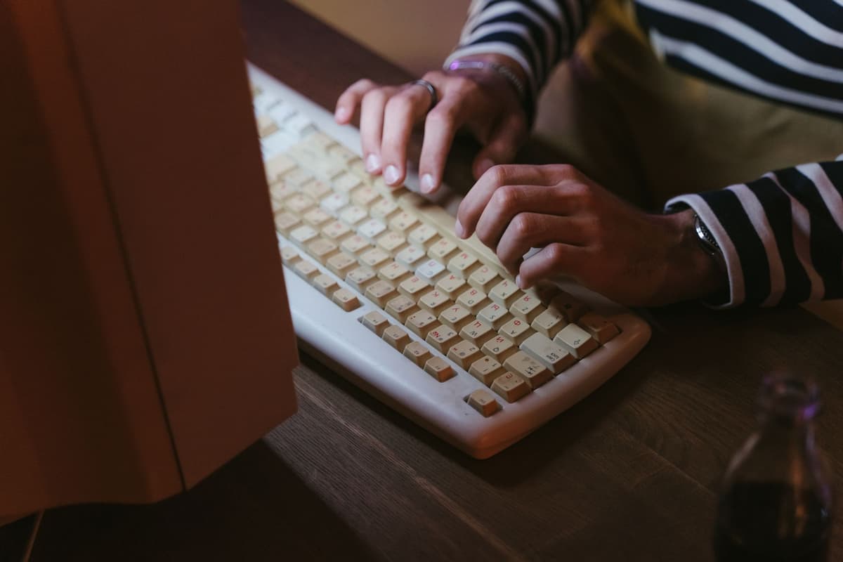 a vintage beige computer tower wearing a tiny tinfoil hat