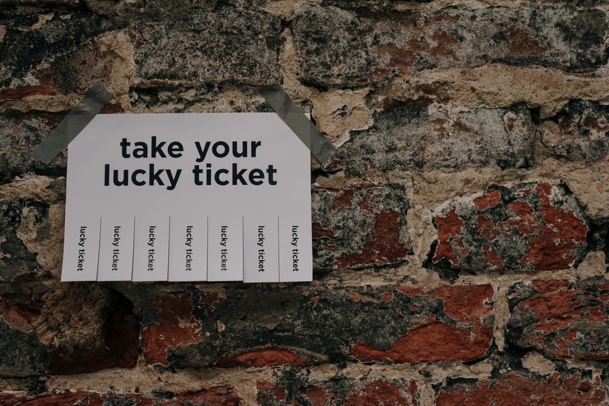 hand-drawn concert poster taped to a brick wall