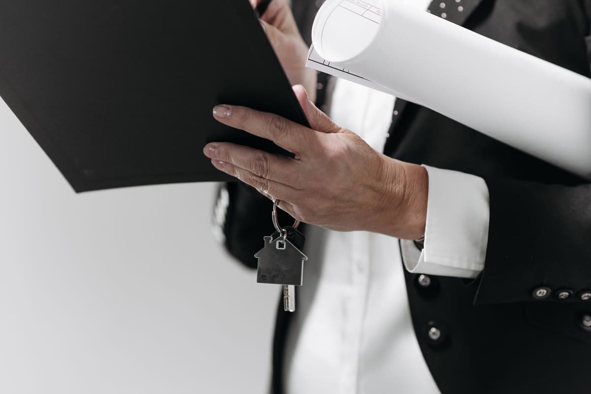 a single silver key sitting on a massive stack of legal documents