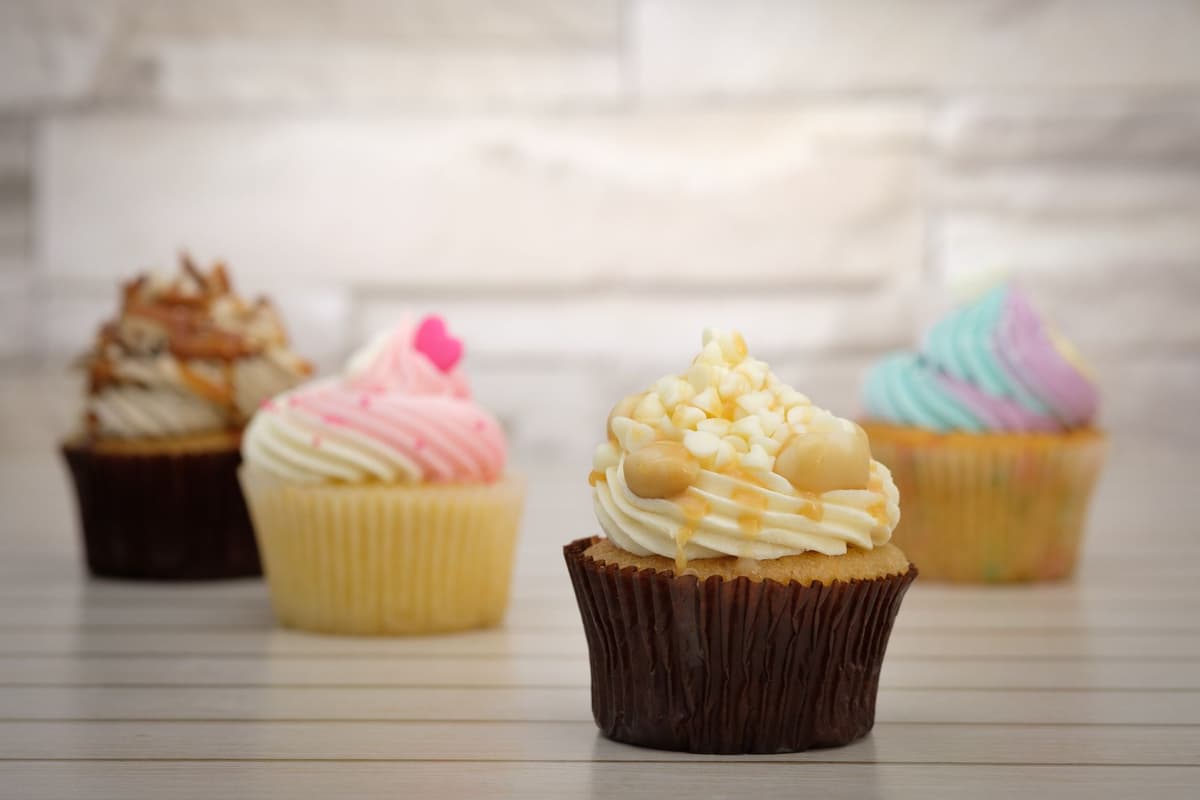 a single dusty cupcake on a flat table