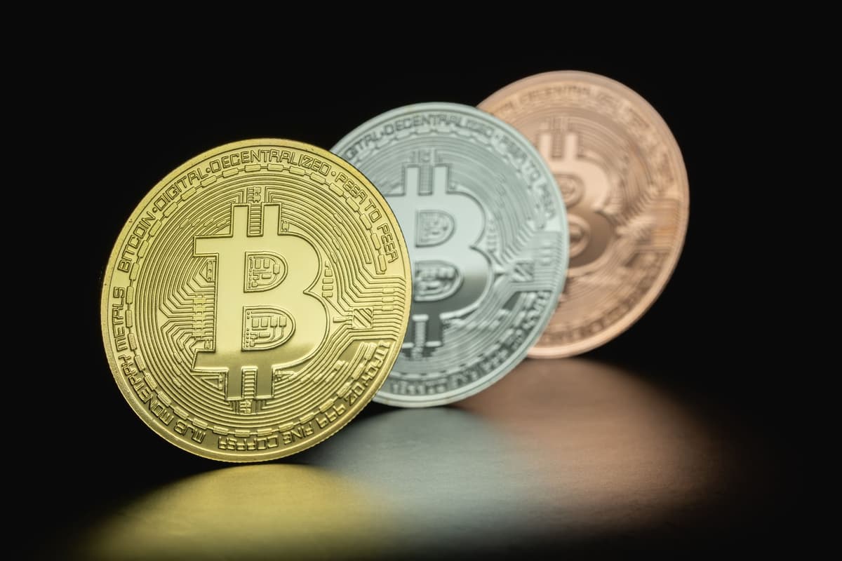 a single gold coin sitting in a pool of dark ink
