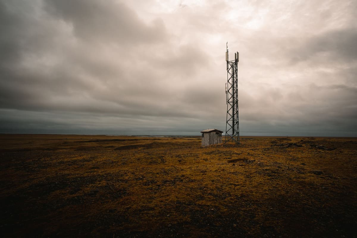 a portable cellular tower parked in a rocky tundra