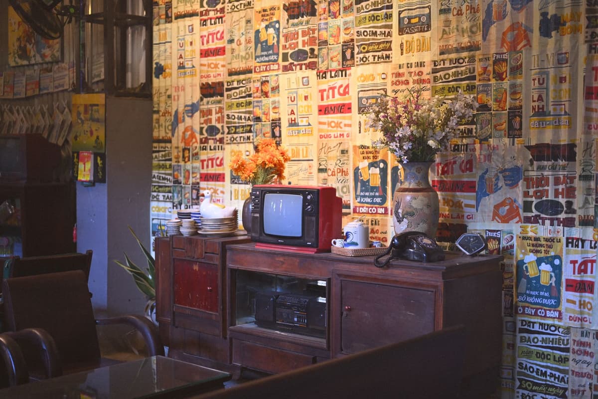 a dusty stack of old magazines next to a glowing high-tech scanner