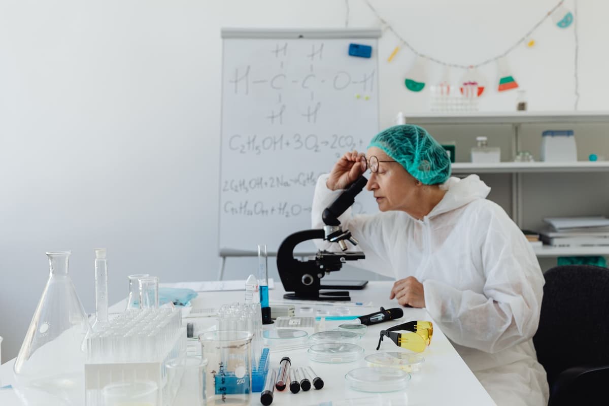a scientist looking at glowing digital DNA strands