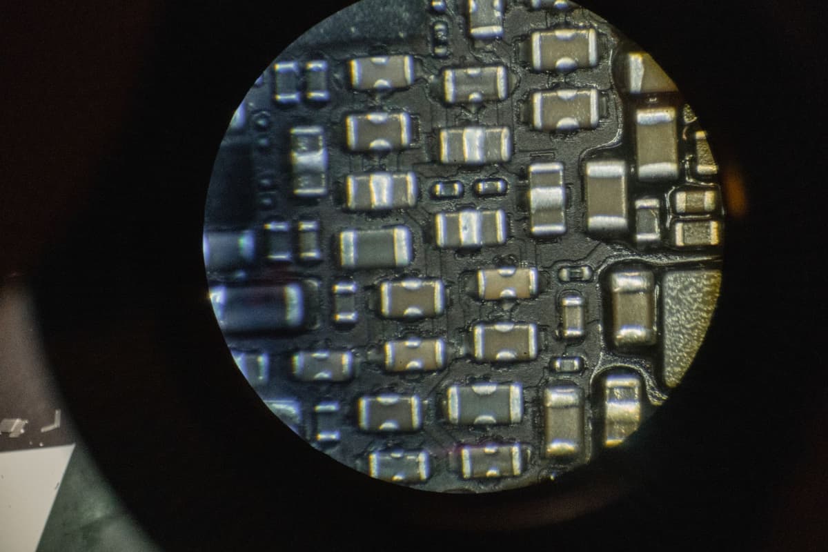 silicon wafer inspected under microscopic laboratory light