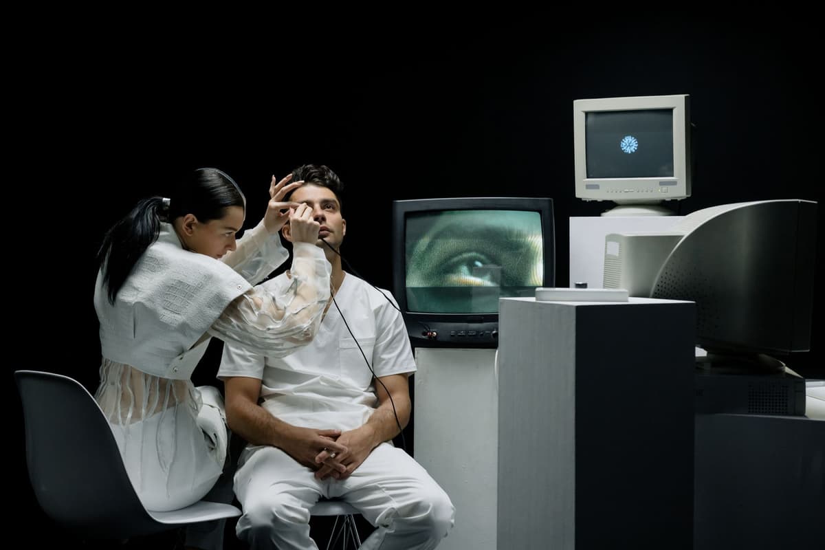 a researcher staring blankly at a glowing monitor