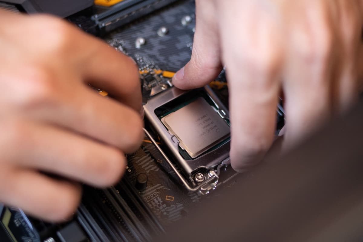 a person using a precision screwdriver on a laptop motherboard