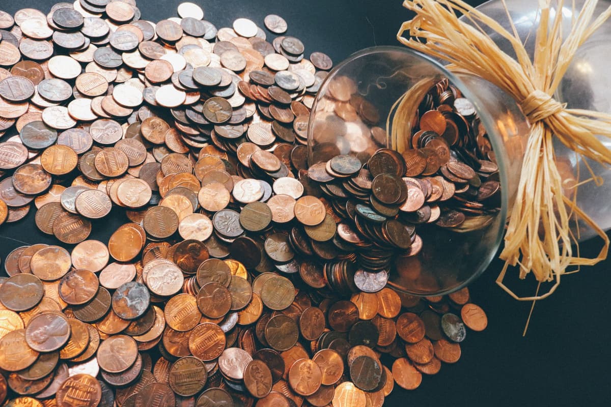 a pile of shiny elongated copper pennies on a table