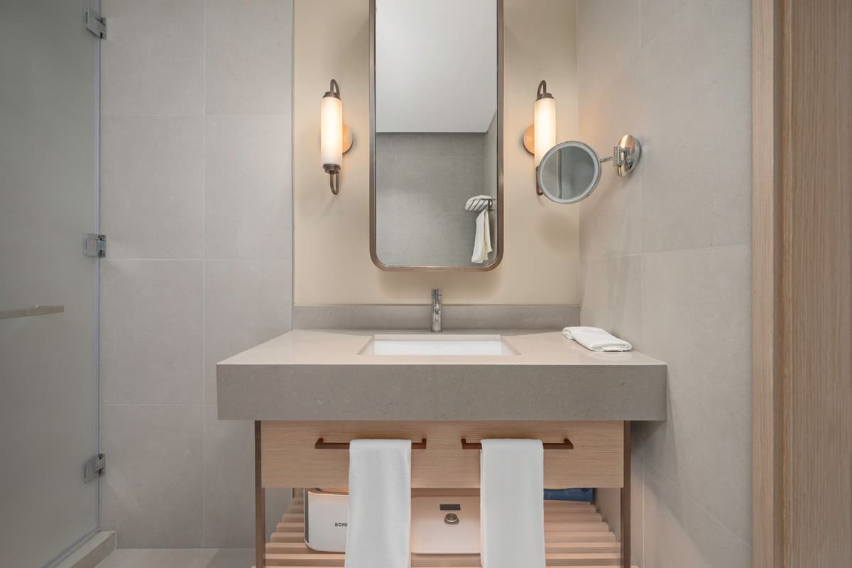 a smartphone propped against a bathroom mirror