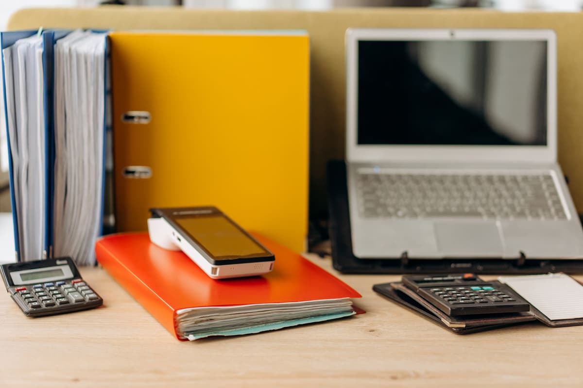 a dusty 1970s calculator sitting next to a sleek modern laptop