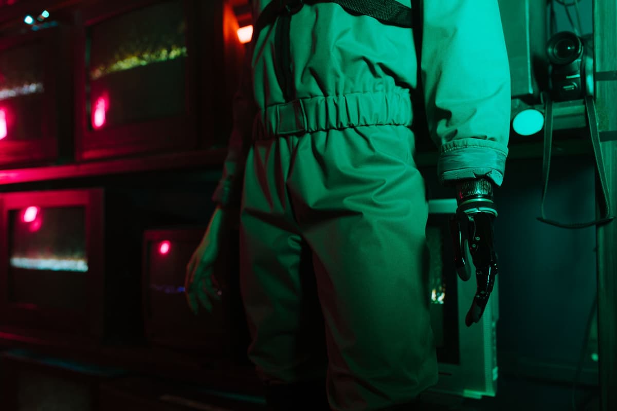 a complex, sterile laboratory with robotic arms and glowing screens