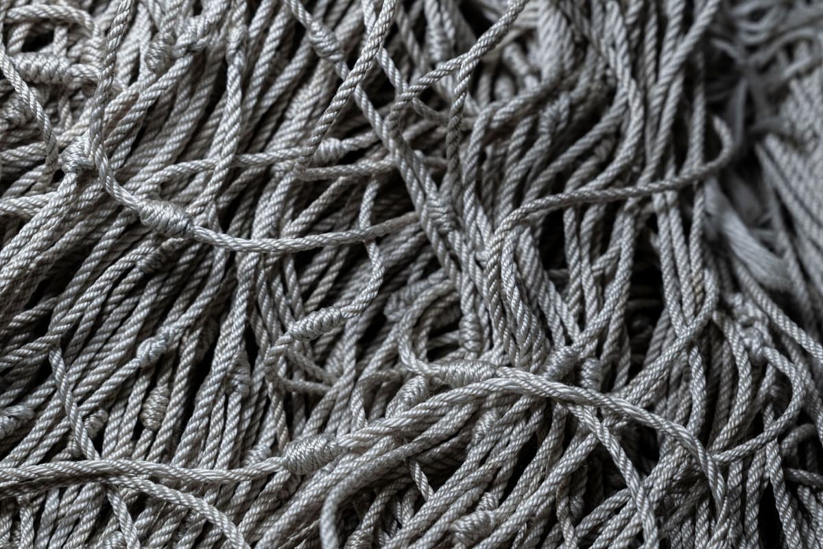 a tangled ball of red and blue yarn, symbolizing complex and interconnected systems