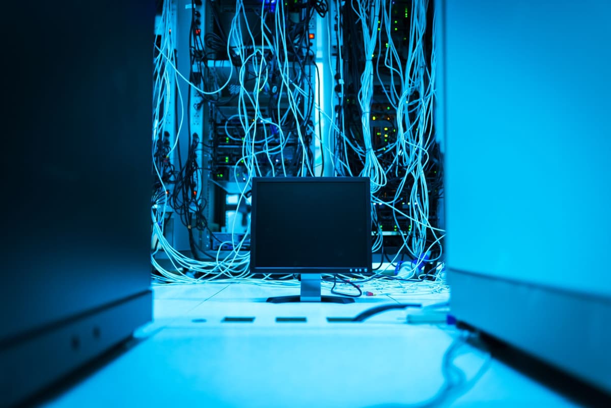 a single glowing server rack in a dark room