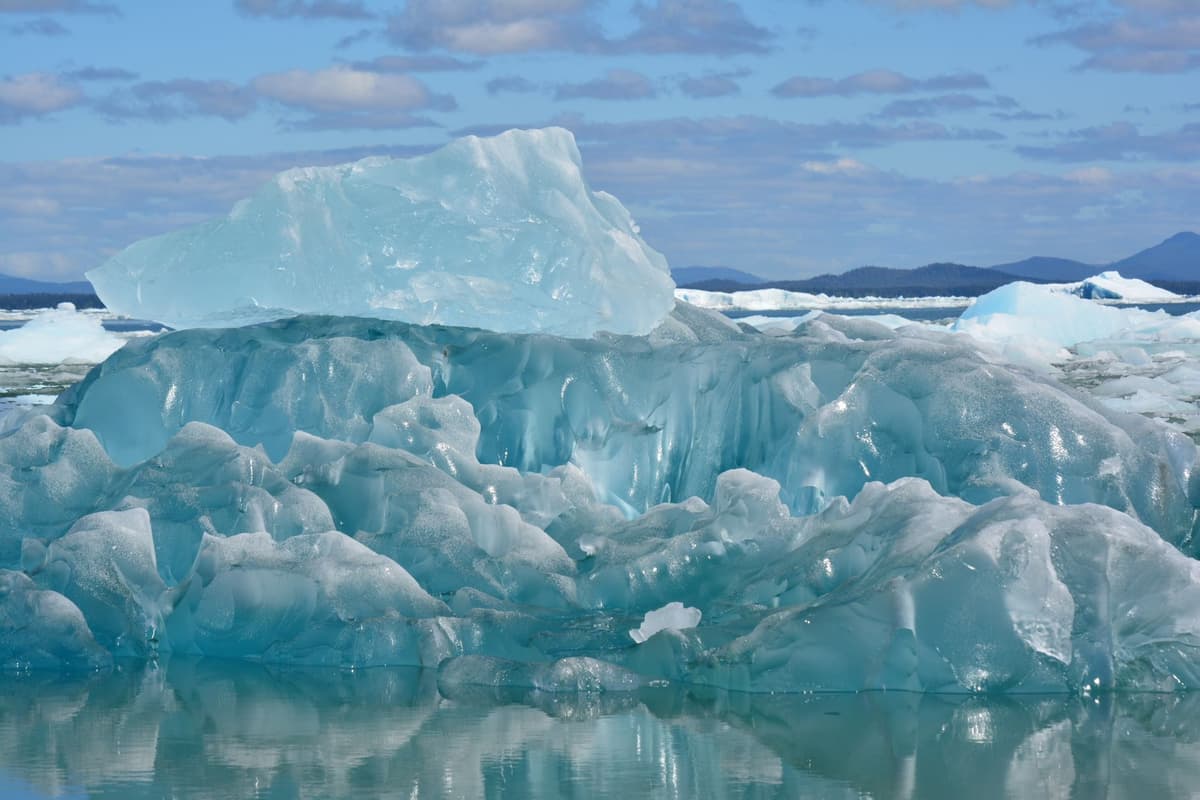 a single crown resting on a blue iceberg