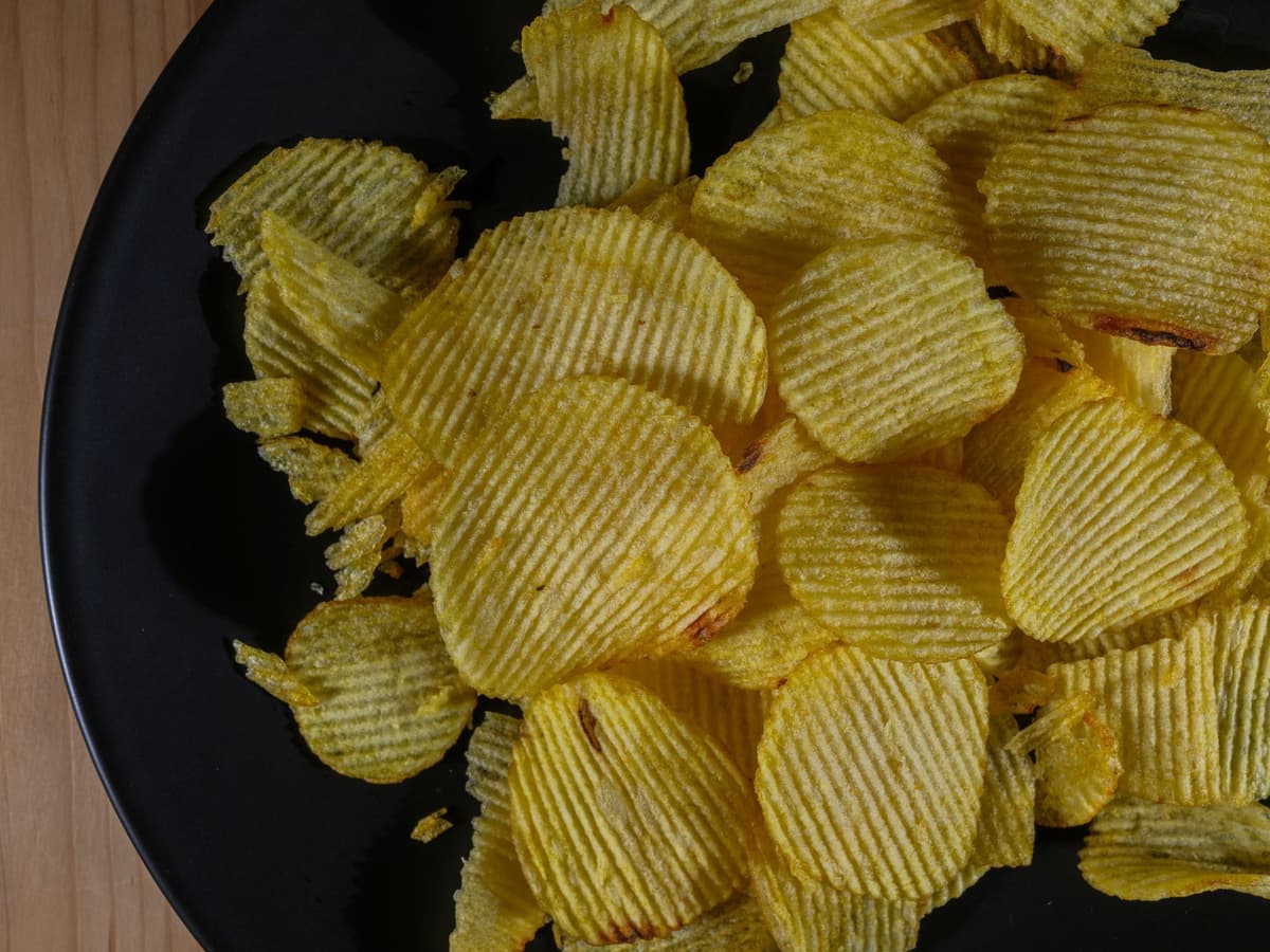 a gold-plated potato on a velvet cushion