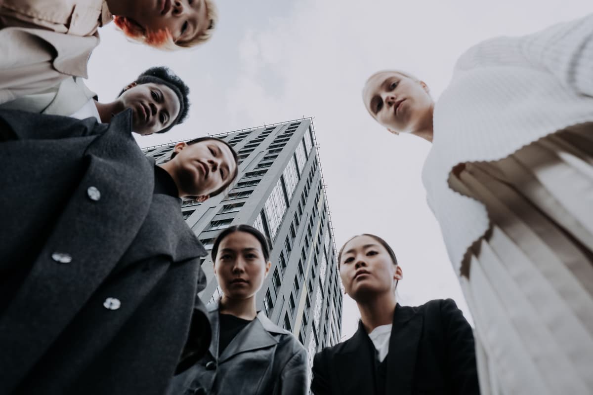 many business people standing in a circle staring down