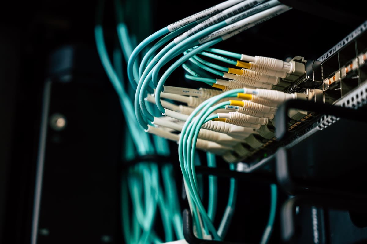 a dusty ethernet cable plugged into a glowing white plastic hub