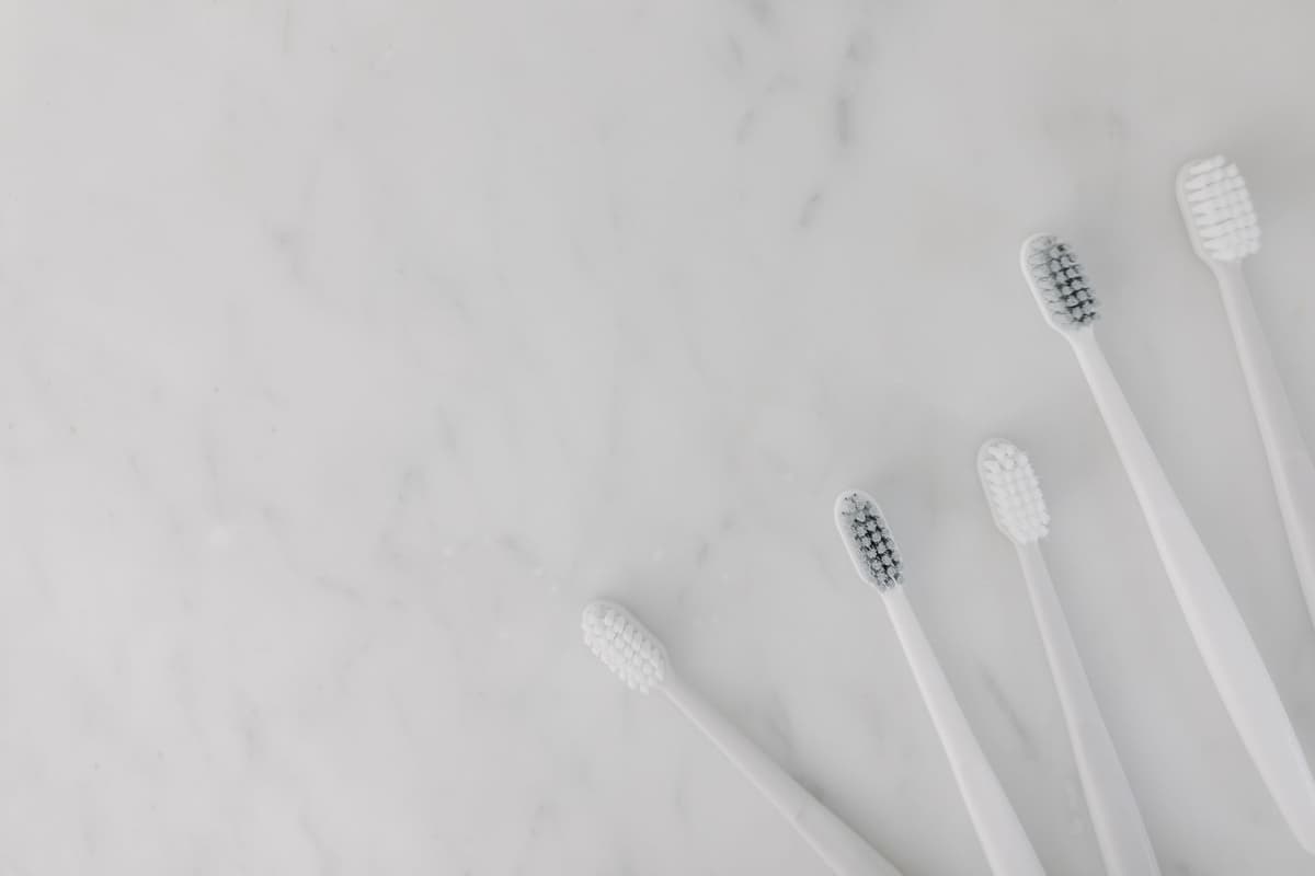 a sleek metal toothbrush charging on a heavy marble vanity