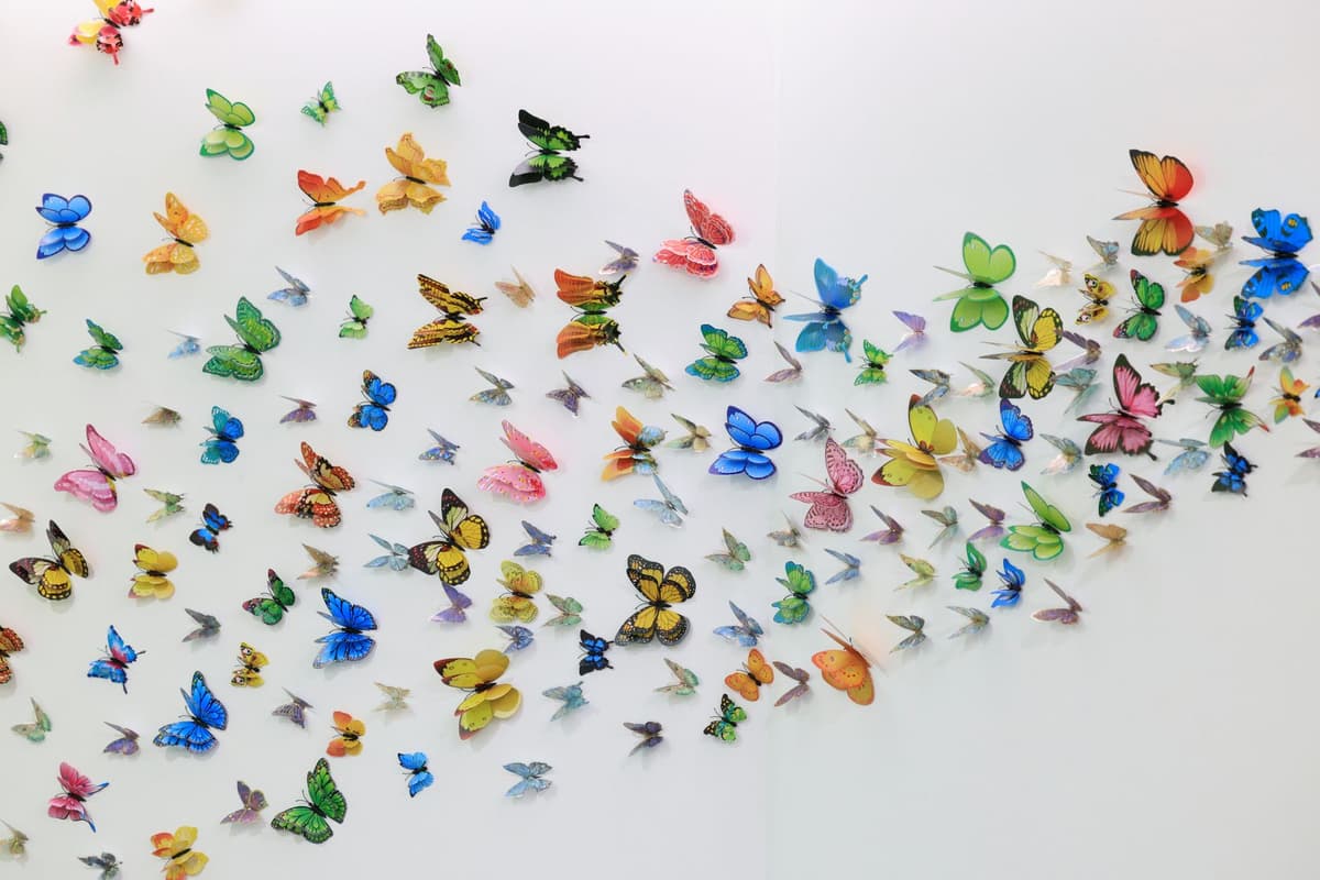 a vintage flyswatter hitting a glowing holographic butterfly