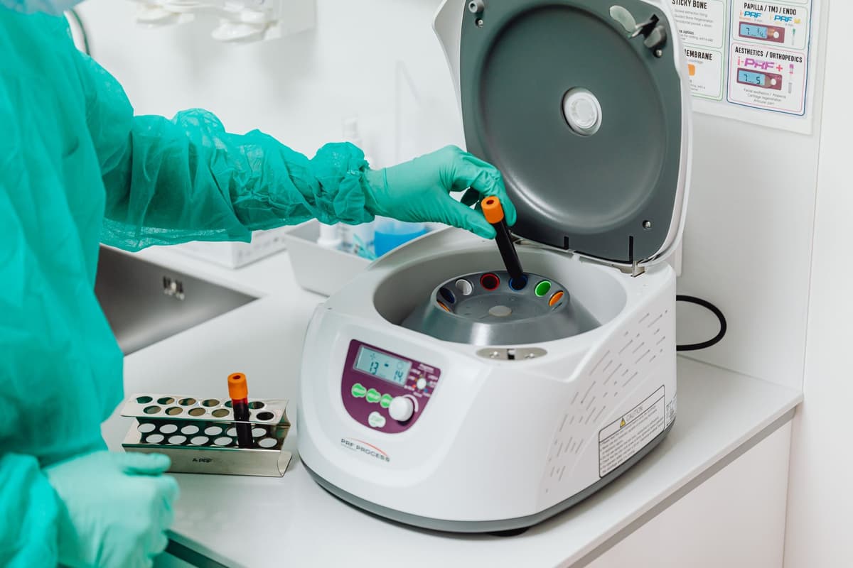 a stainless steel laboratory centrifuge spinning glass vials