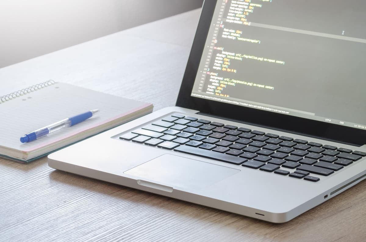 a high-end laptop open in a dark office