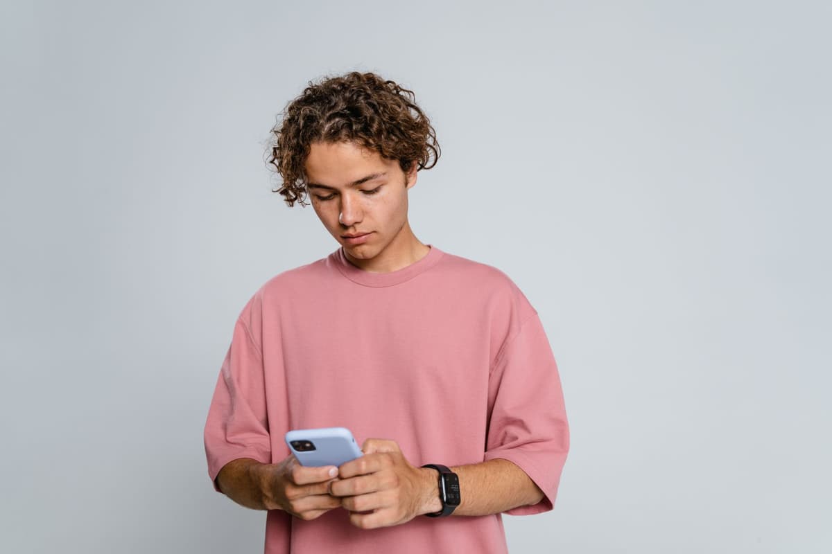 a person wearing a futuristic wristband, looking stressed at their phone